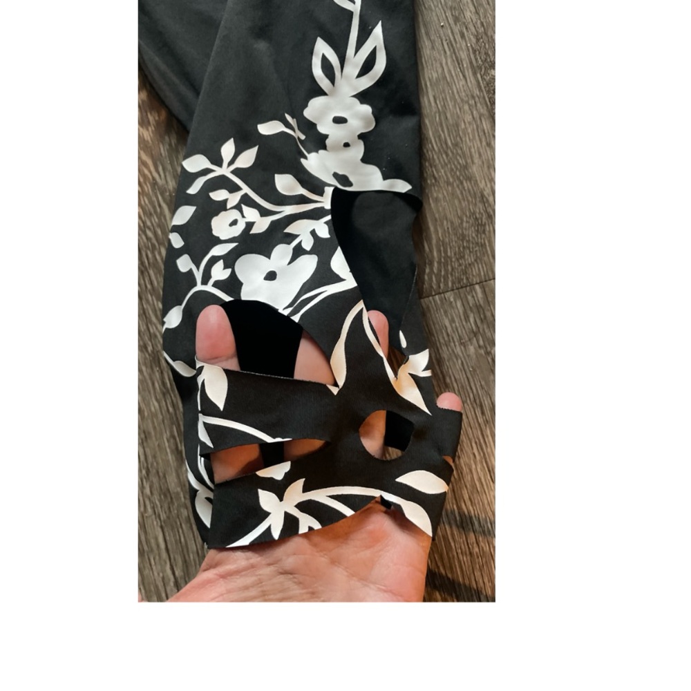 WORN ONCE! SUPER CUTE CAPRI PANTS WITH FLORAL HEM AND HOLE ACCENTS! - Picture 4 of 9